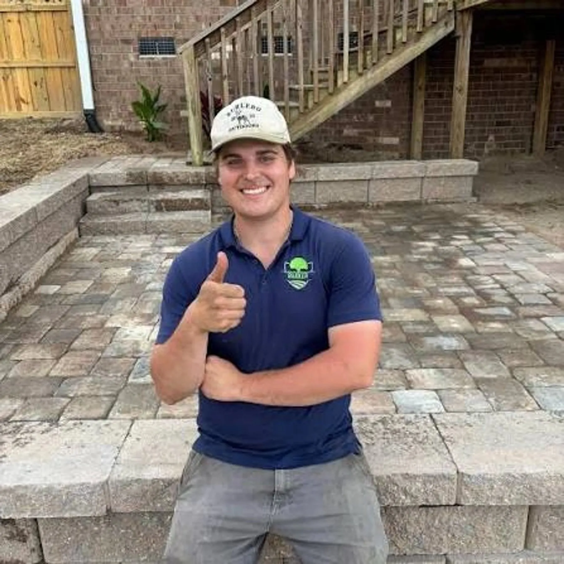 Dalton Barker, owner, on a finished paver patio job site