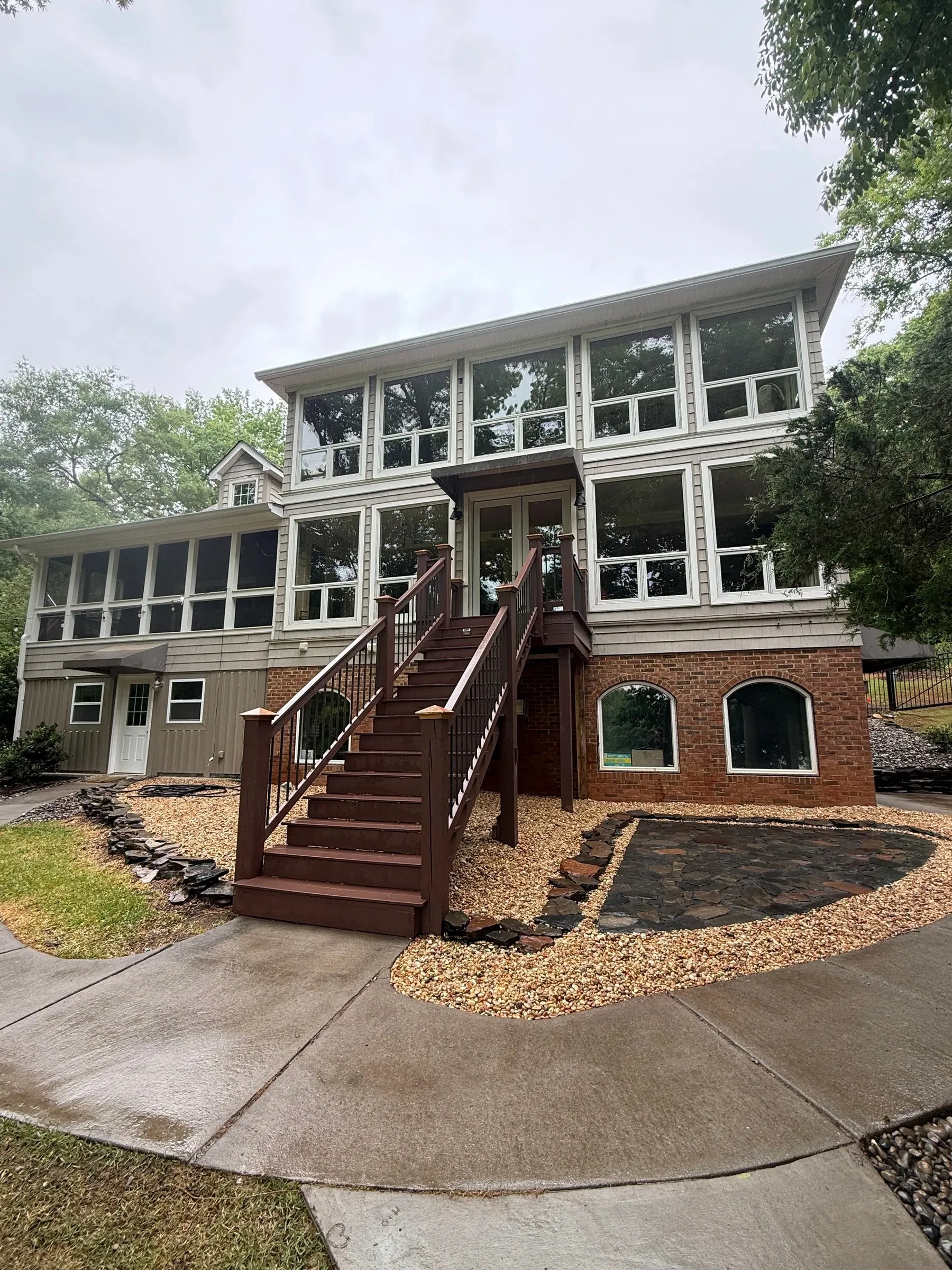 Two-story home with a new wooden stair deck and fresh mulch beds