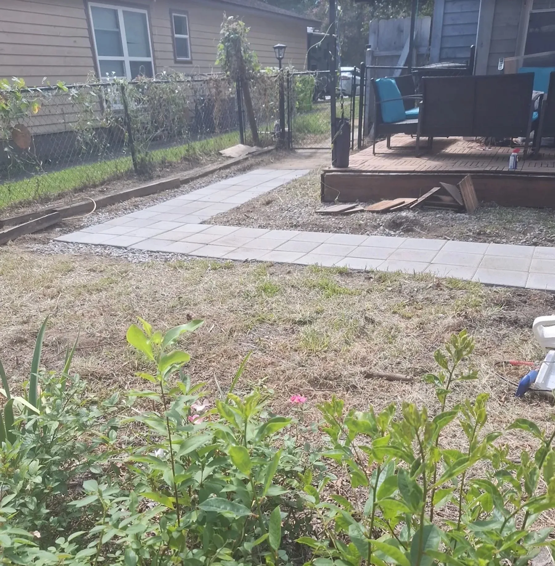 New concrete walkway formed and poured beside a deck on a regraded yard